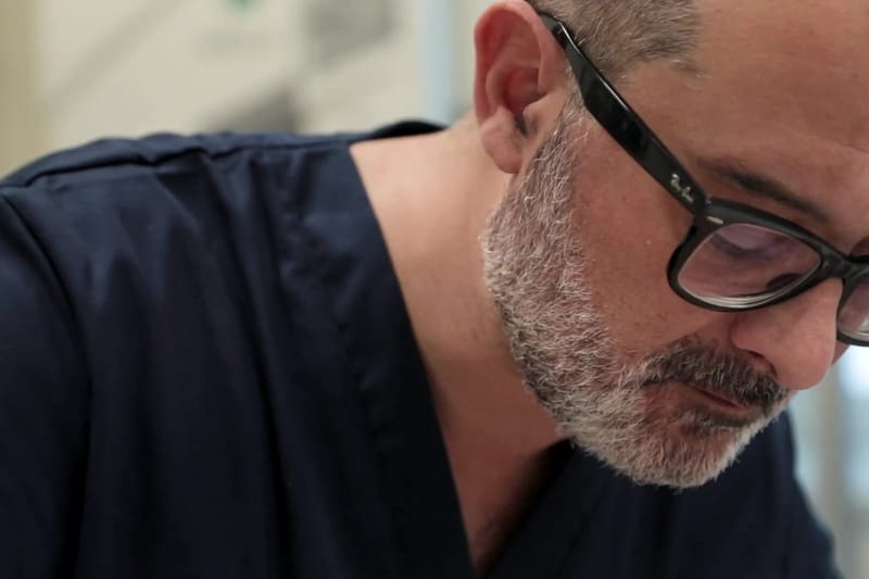Il Prof. Coricciati, chino e concentrato, durante un trattamento con gli ultrasuoni